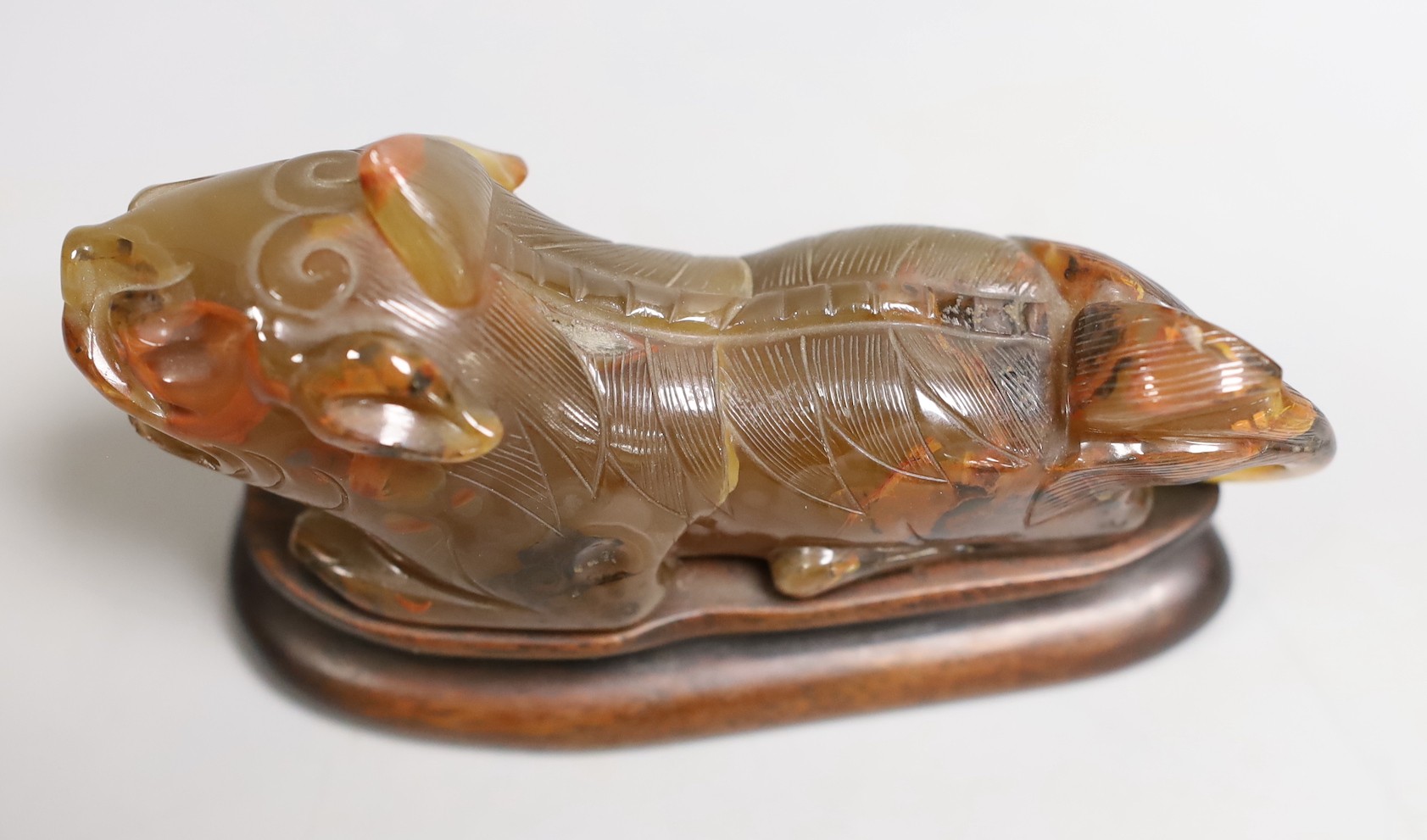 A Chinese agate recumbent lion dog 13cm long